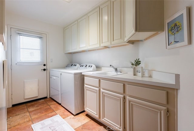 laundry room featuring washer and clothes dryer, a sink, and cabinet space
