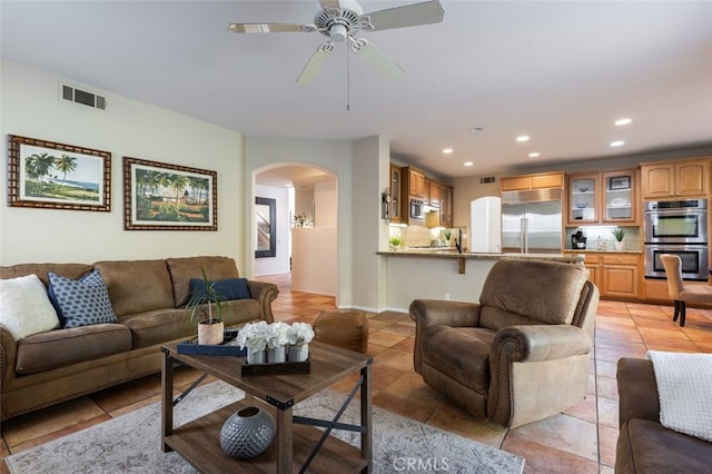 tiled living room featuring ceiling fan