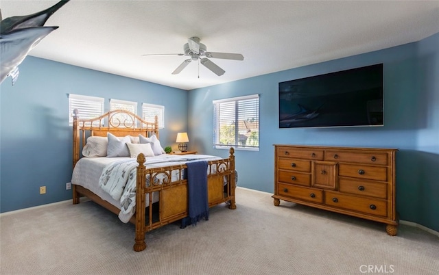 bedroom with light colored carpet and ceiling fan