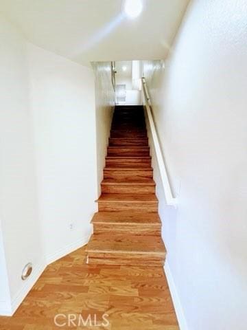 stairs with hardwood / wood-style floors