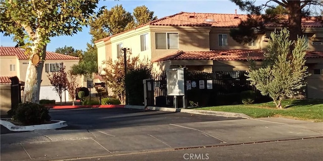 exterior space featuring stucco siding and a tile roof