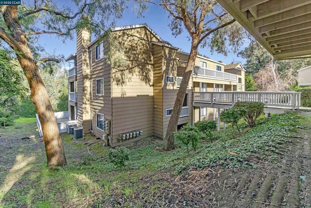 back of house with central AC and a deck