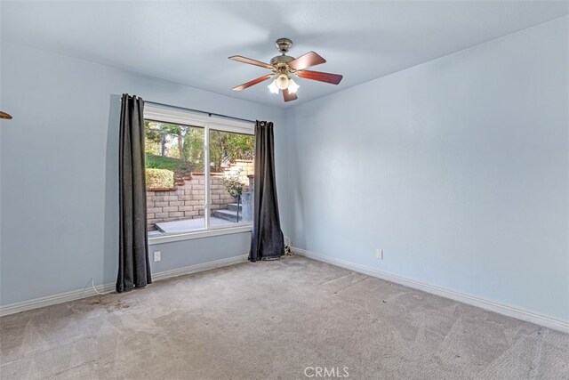 empty room featuring ceiling fan, light carpet, and a healthy amount of sunlight