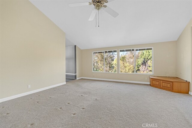 unfurnished room featuring vaulted ceiling, ceiling fan, and carpet floors