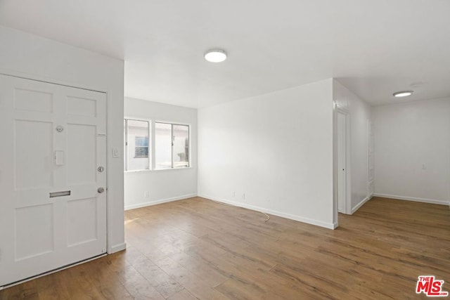 entryway with hardwood / wood-style floors