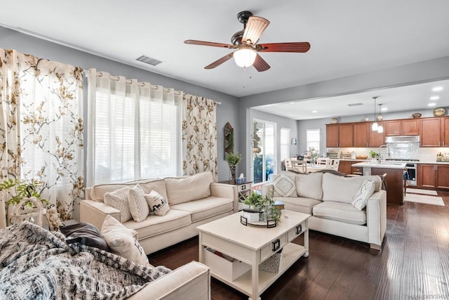 living room featuring dark hardwood / wood-style floors and ceiling fan