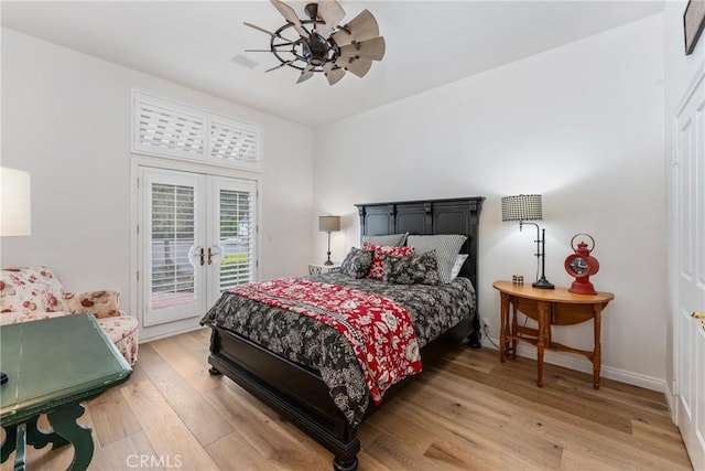 bedroom featuring french doors, ceiling fan, wood-type flooring, and access to outside