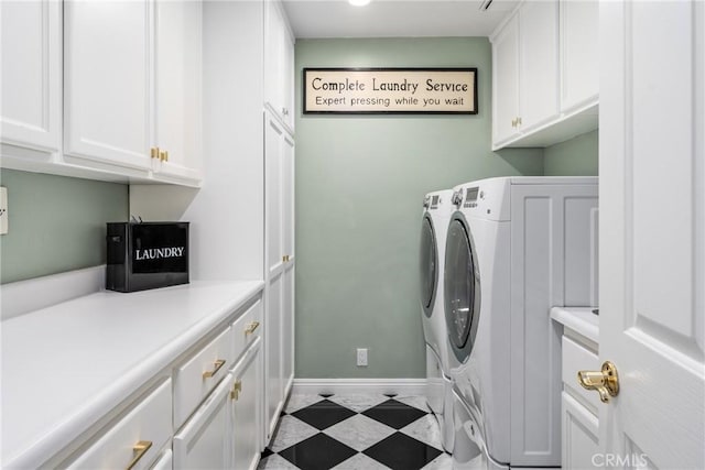 laundry room with cabinets and washer and clothes dryer