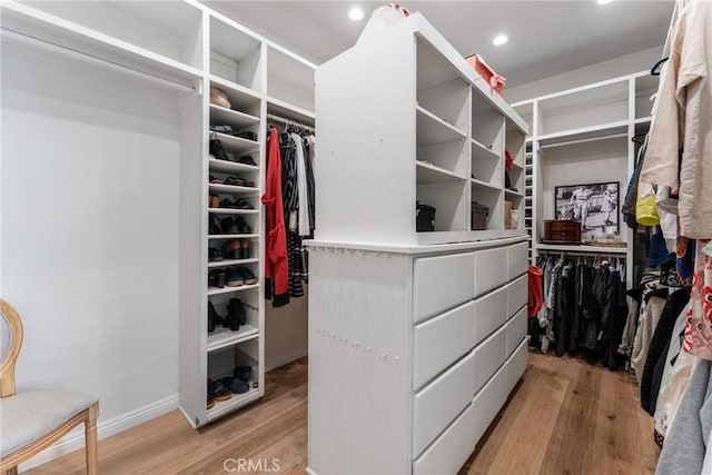 walk in closet with light wood-type flooring