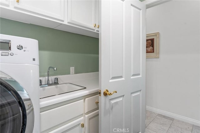 washroom with washer / clothes dryer, sink, and cabinets