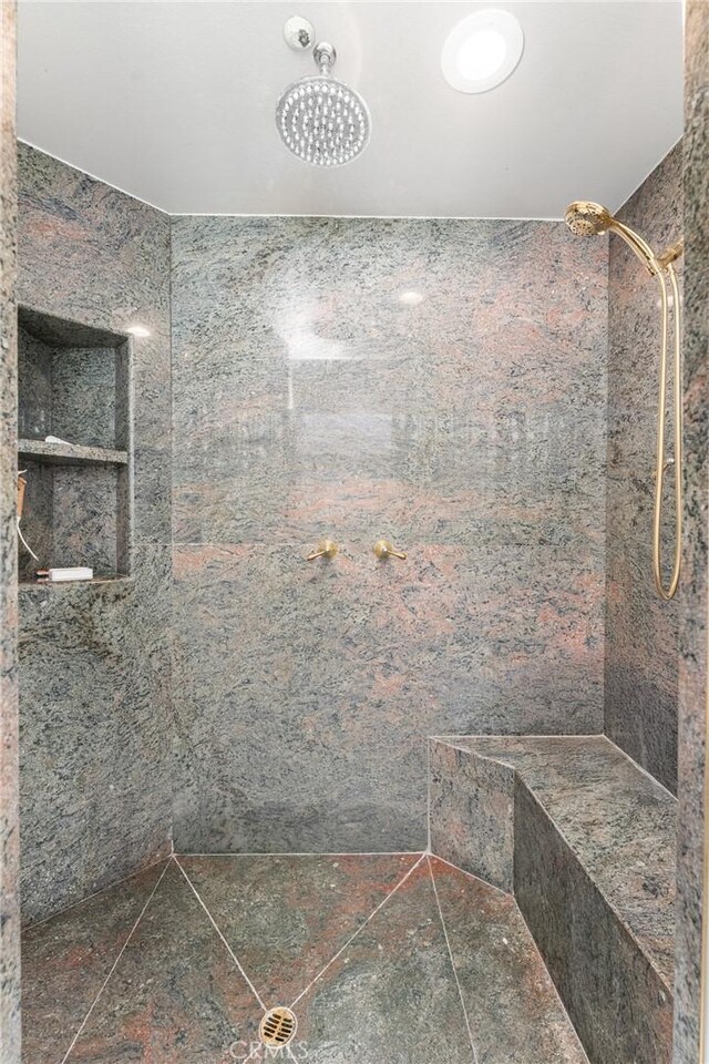 bathroom with tiled shower