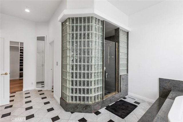 interior space featuring tile patterned floors and walk in shower