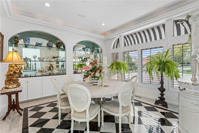 tiled dining room with a raised ceiling