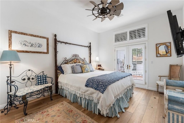 bedroom featuring wood-type flooring, access to exterior, ceiling fan, and french doors