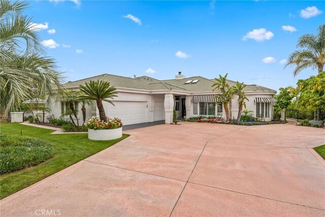 view of front of house featuring a garage and a front lawn