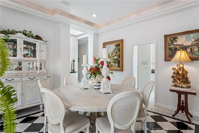 tiled dining room featuring crown molding