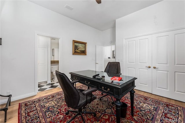 office area with ceiling fan and light hardwood / wood-style flooring