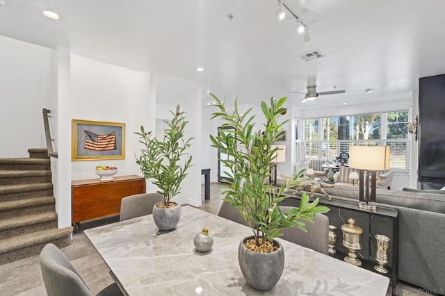 dining space featuring ceiling fan, light hardwood / wood-style floors, and track lighting