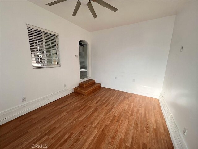 spare room featuring light hardwood / wood-style flooring and ceiling fan