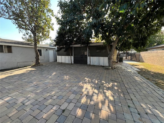 exterior space featuring a sunroom and a patio