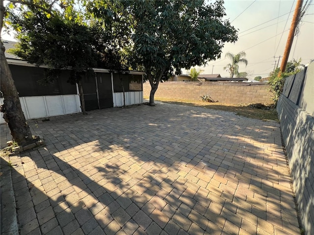 view of patio with a sunroom