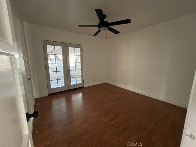 spare room with french doors, dark hardwood / wood-style floors, and ceiling fan