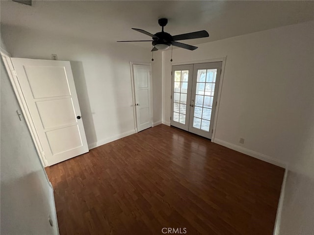 unfurnished room with dark hardwood / wood-style flooring, ceiling fan, and french doors