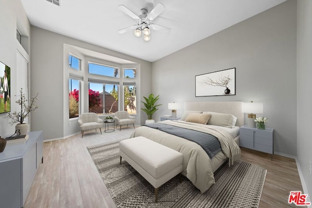 bedroom featuring wood-type flooring, vaulted ceiling, and ceiling fan