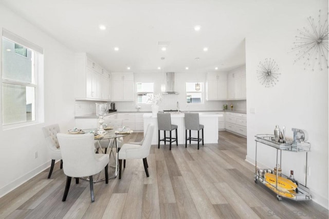 dining room featuring sink, plenty of natural light, and light wood-type flooring