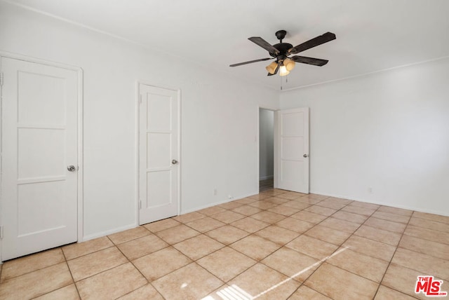 unfurnished bedroom featuring ceiling fan and light tile patterned floors