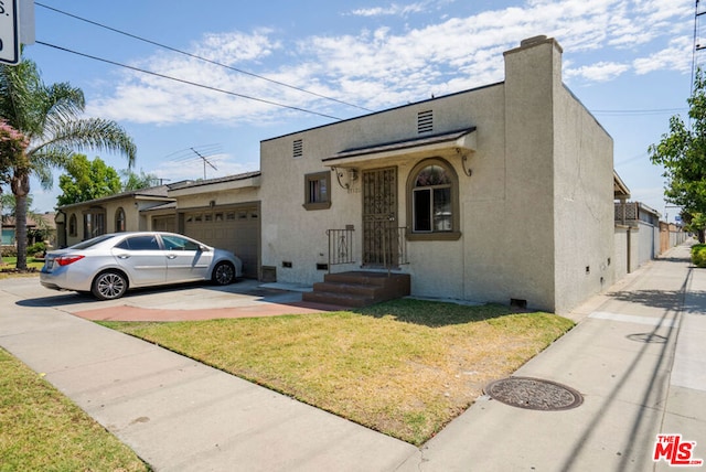 view of front of property with a front lawn and a garage