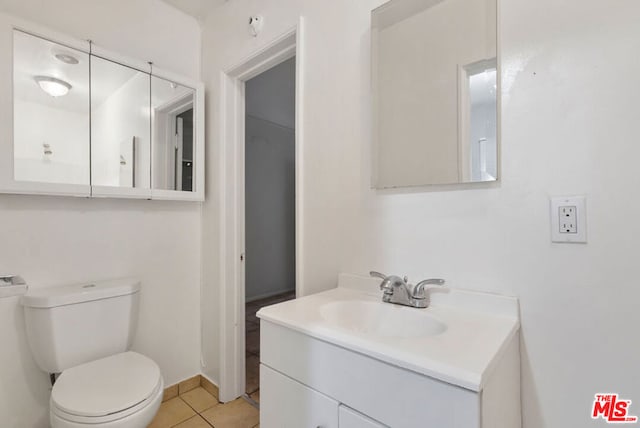 bathroom featuring tile patterned floors, vanity, and toilet