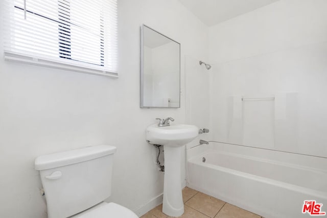 bathroom with tile patterned flooring, toilet, and bathtub / shower combination