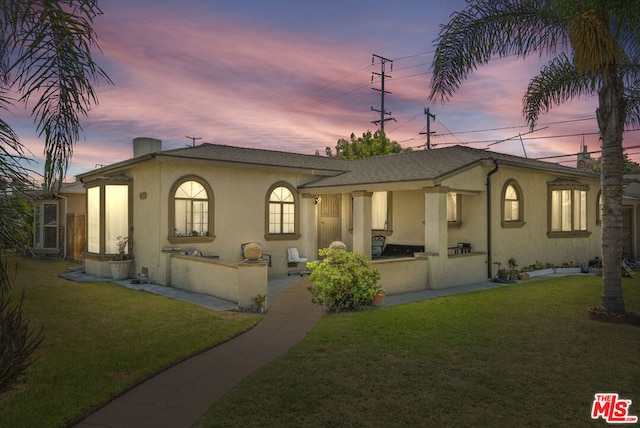 view of front of house with a lawn