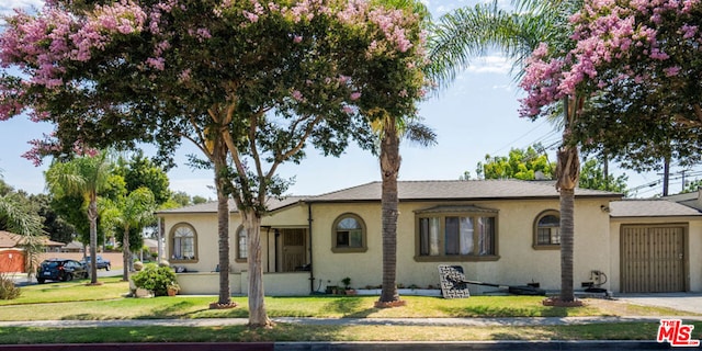 ranch-style home with a front lawn