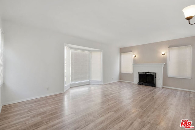 unfurnished living room featuring light wood-type flooring