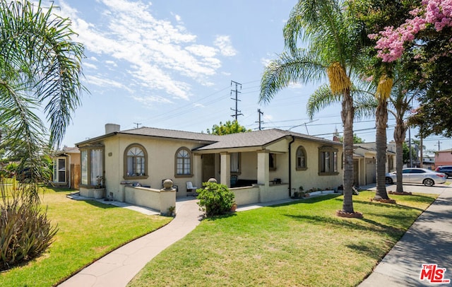 view of front of property featuring a front yard and a garage