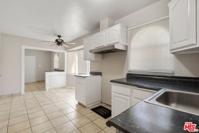 kitchen with ceiling fan, white cabinetry, sink, and light tile patterned floors