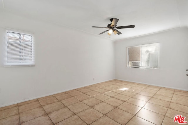 tiled spare room with ceiling fan and ornamental molding