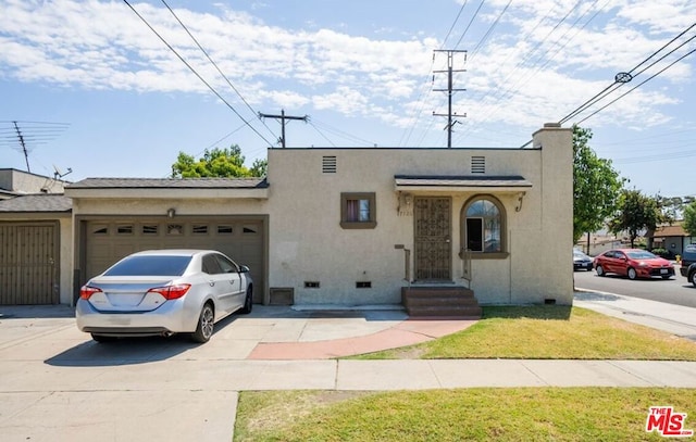 view of front of house with a front lawn and a garage