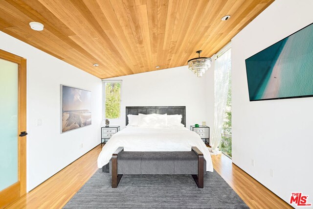 bedroom featuring a chandelier, wooden ceiling, lofted ceiling, and hardwood / wood-style flooring