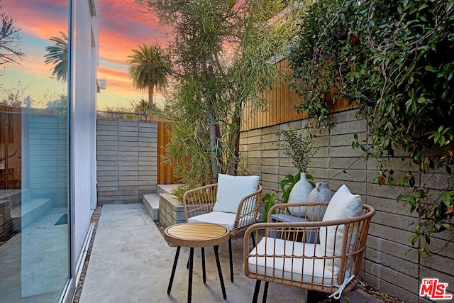 view of patio terrace at dusk