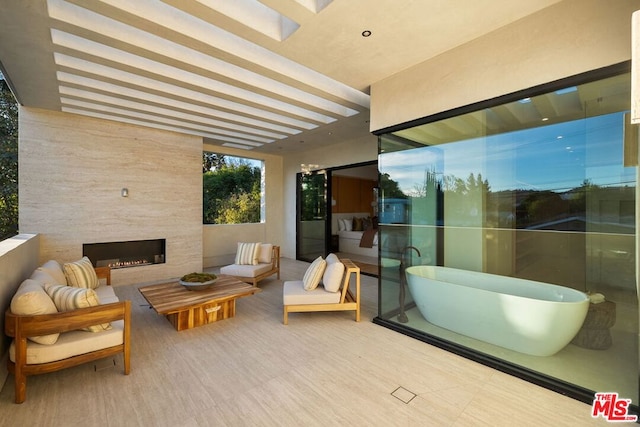 view of patio / terrace with an outdoor living space with a fireplace