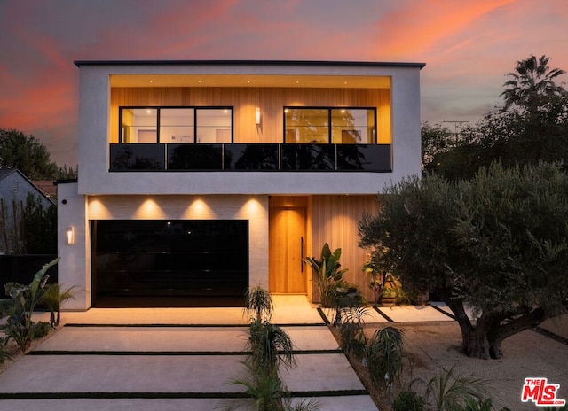 modern home with a garage and a balcony