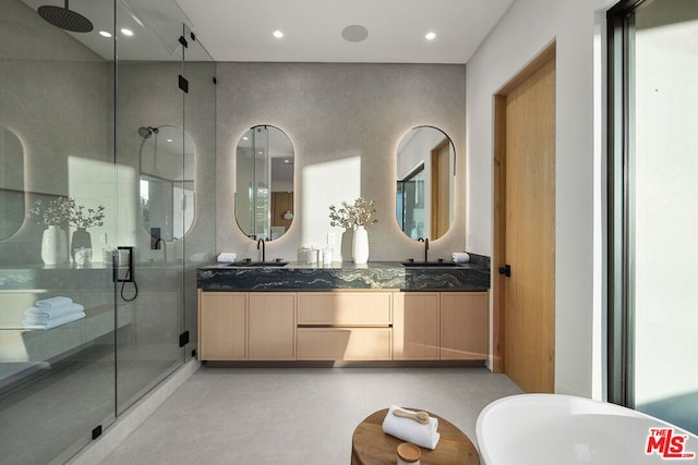 bathroom with vanity and shower with separate bathtub