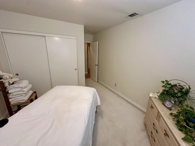 bedroom with light colored carpet and a closet