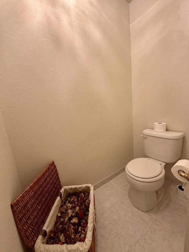 bathroom featuring toilet and tile patterned flooring