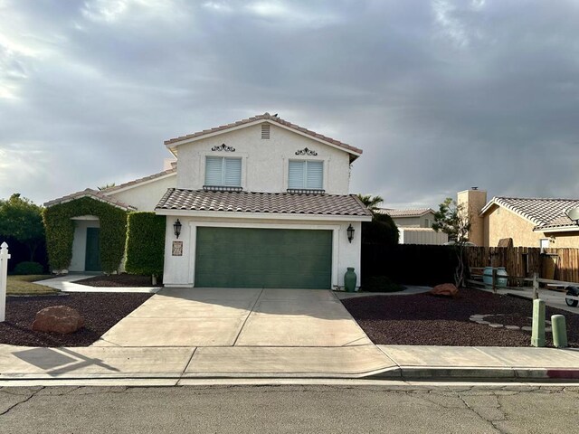 mediterranean / spanish-style home featuring a garage