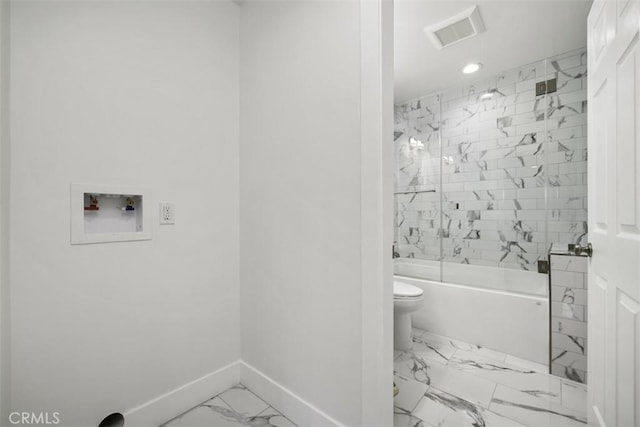 bathroom featuring toilet and enclosed tub / shower combo