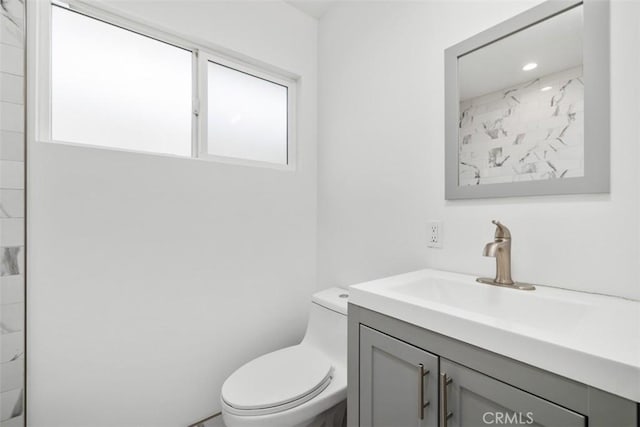 bathroom featuring vanity and toilet